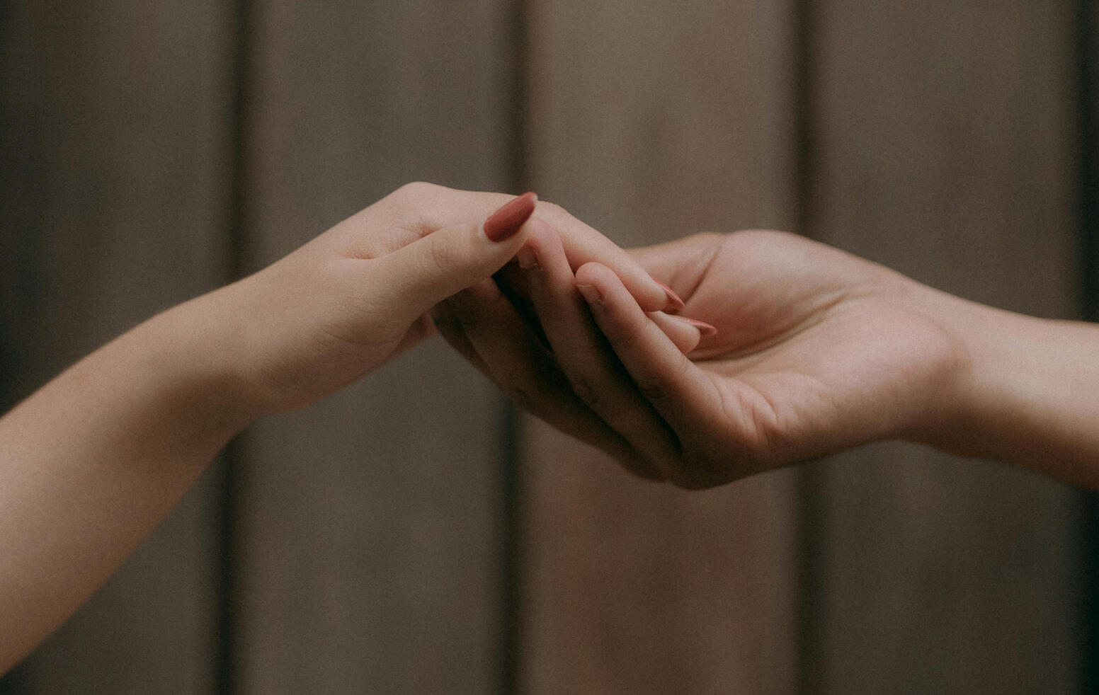 two hands holding each other