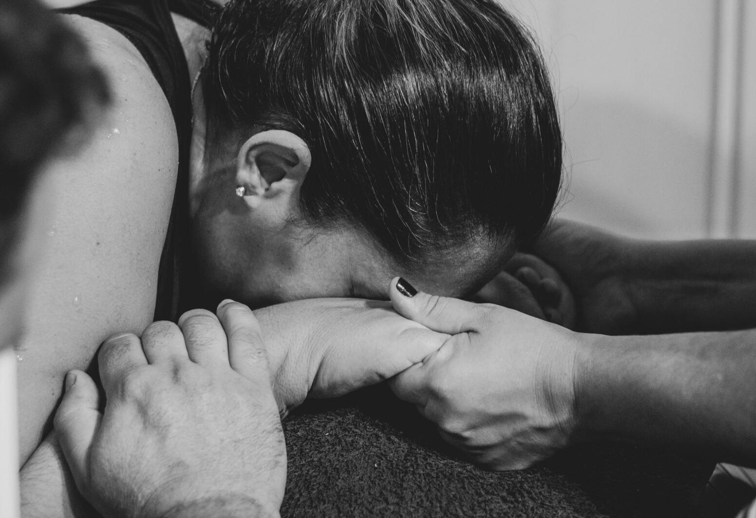 a woman lying on a partners knees